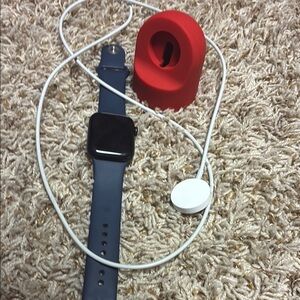 Apple Smartwatch with Blue Band and Red Stand